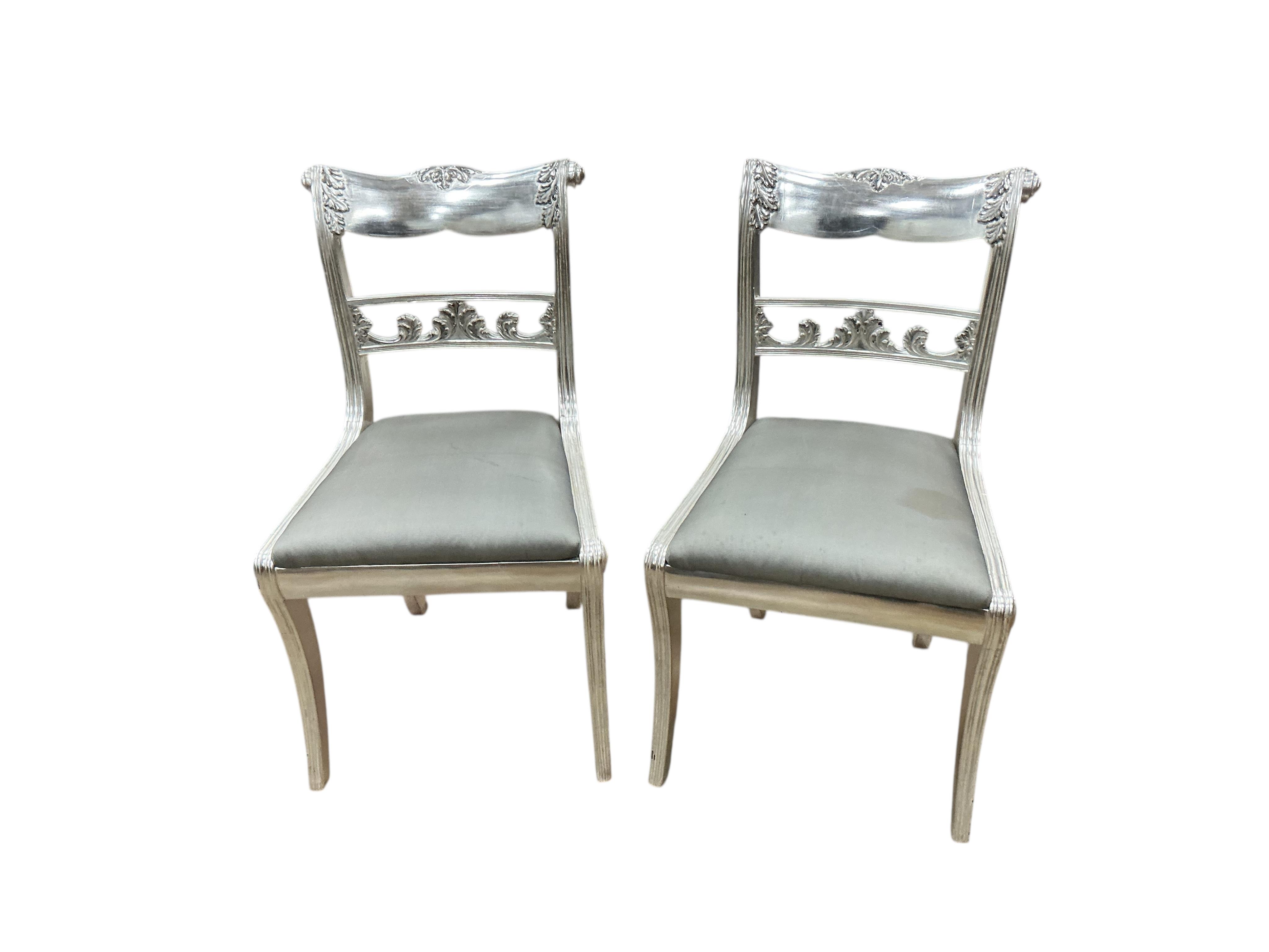 A set of seven Ben Whistler Regency style silvered wood dining chairs, two with arms